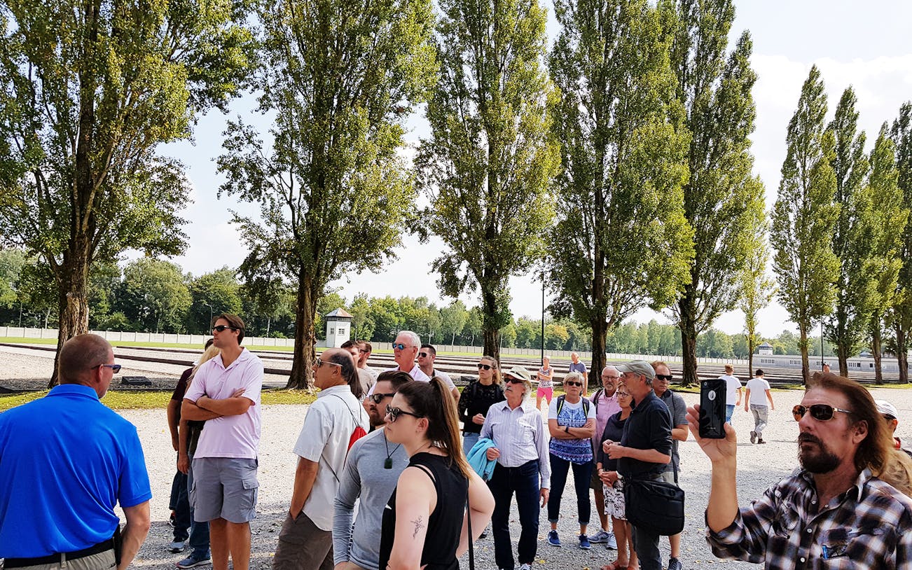 Visitors on a guided tour at Dachau Concentration Camp Memorial Site, Germany.