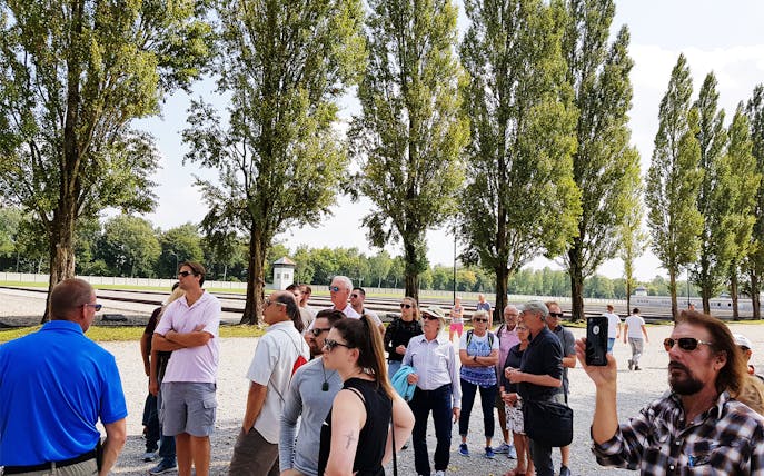 Visitors on a guided tour at Dachau Concentration Camp Memorial Site, Germany.