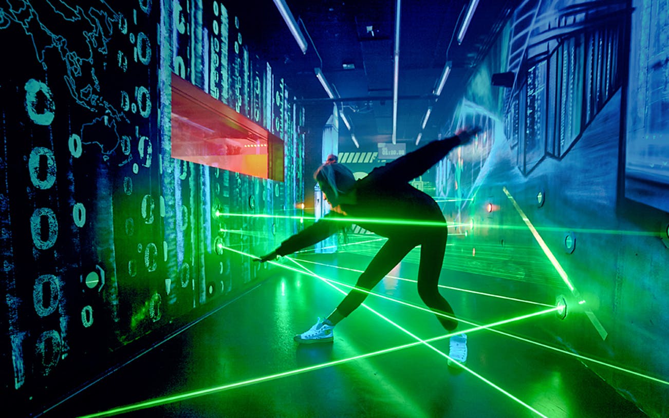 Person navigating laser maze at German Spy Museum, Berlin.