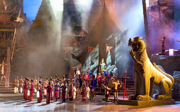 Siam Niramit Bangkok cultural performance with traditional costumes and large mythical statue.