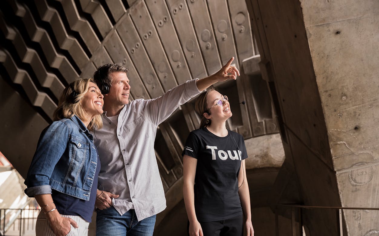 Tour guide showing visitors backstage at Sydney Opera House.