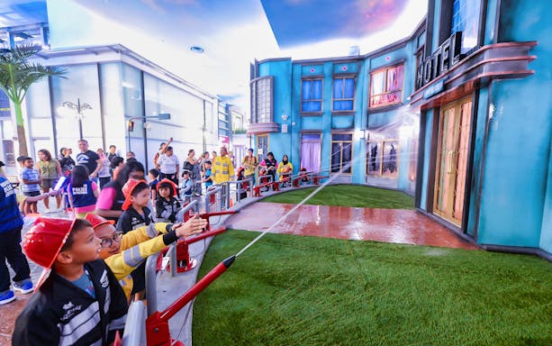 Children participating in a firefighting activity at Kidzania Bangkok.
