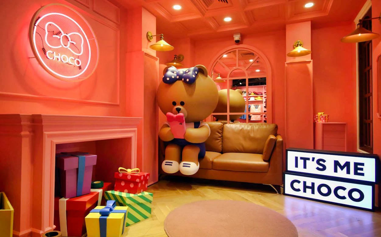 Choco character display at LINE Village Bangkok with colorful gift boxes.