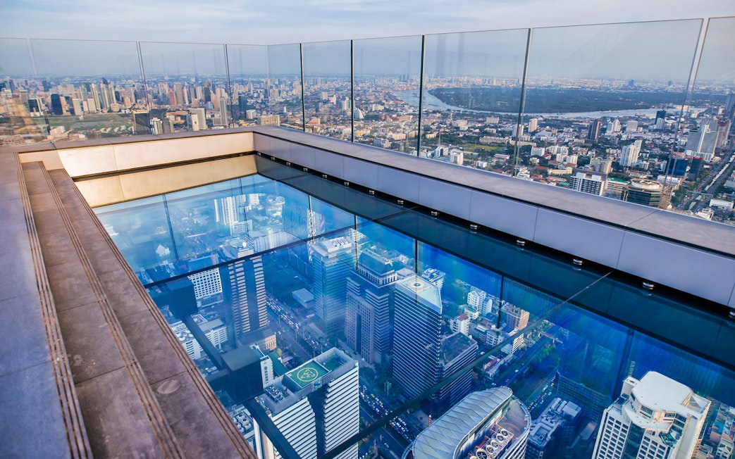 Mahanakhon SkyWalk glass floor with Bangkok city view.