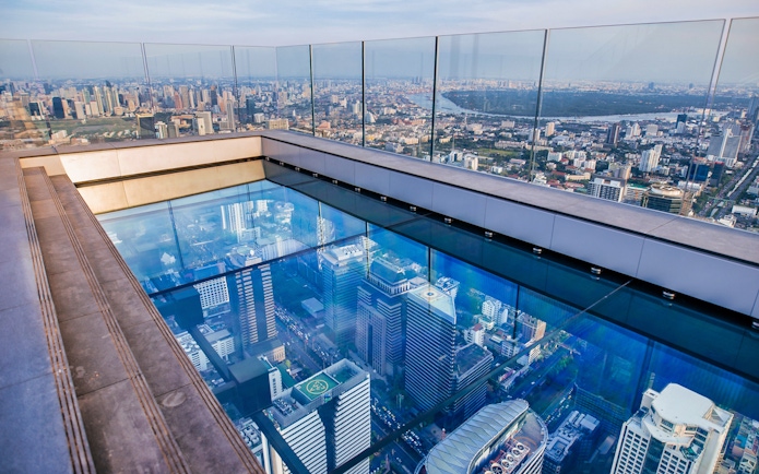 Mahanakhon SkyWalk glass floor with Bangkok city view.