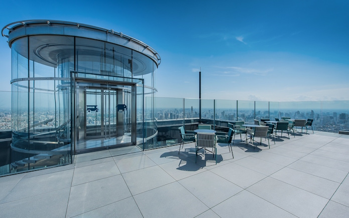 Mahanakhon SkyWalk outdoor terrace with city view and glass elevator in Bangkok.