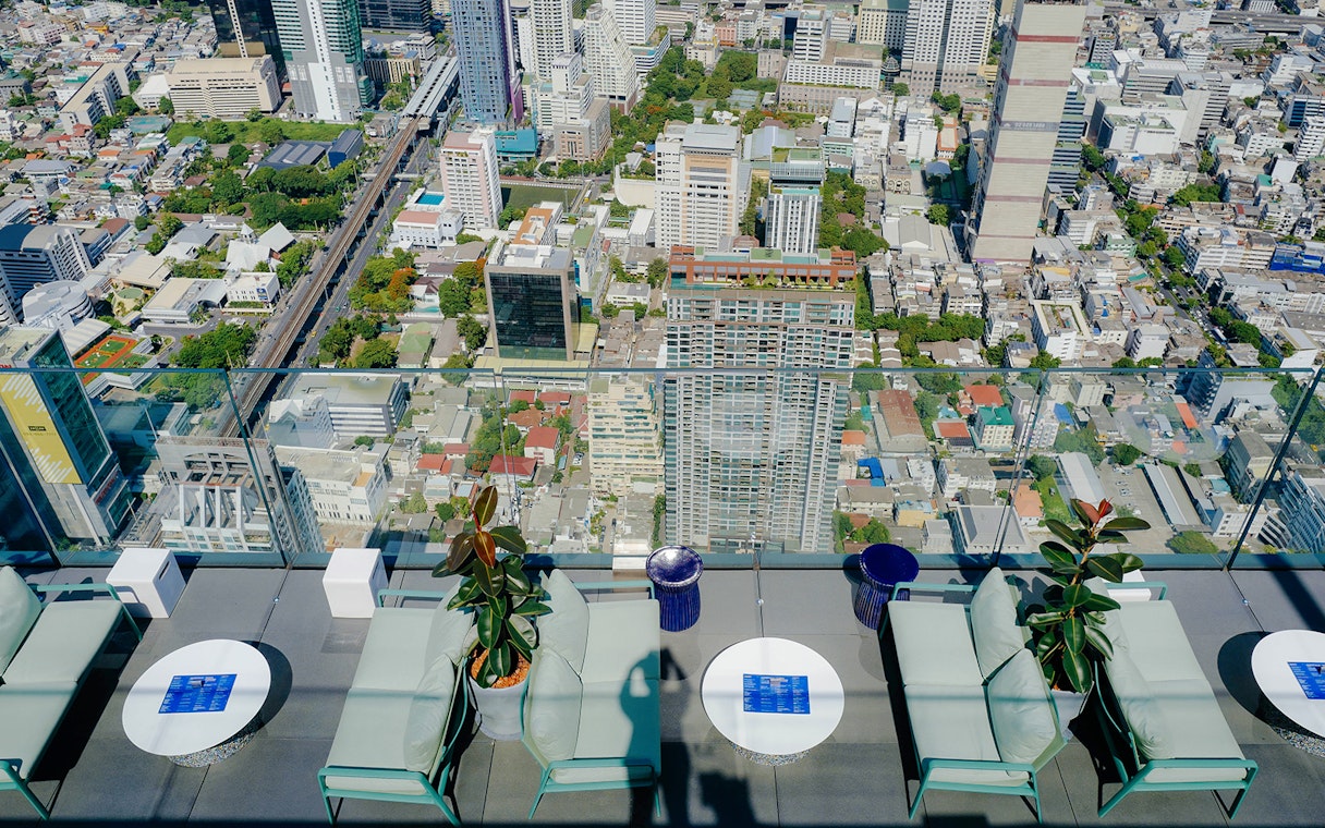 Rooftop view from Mahanakhon SkyWalk overlooking Bangkok cityscape.