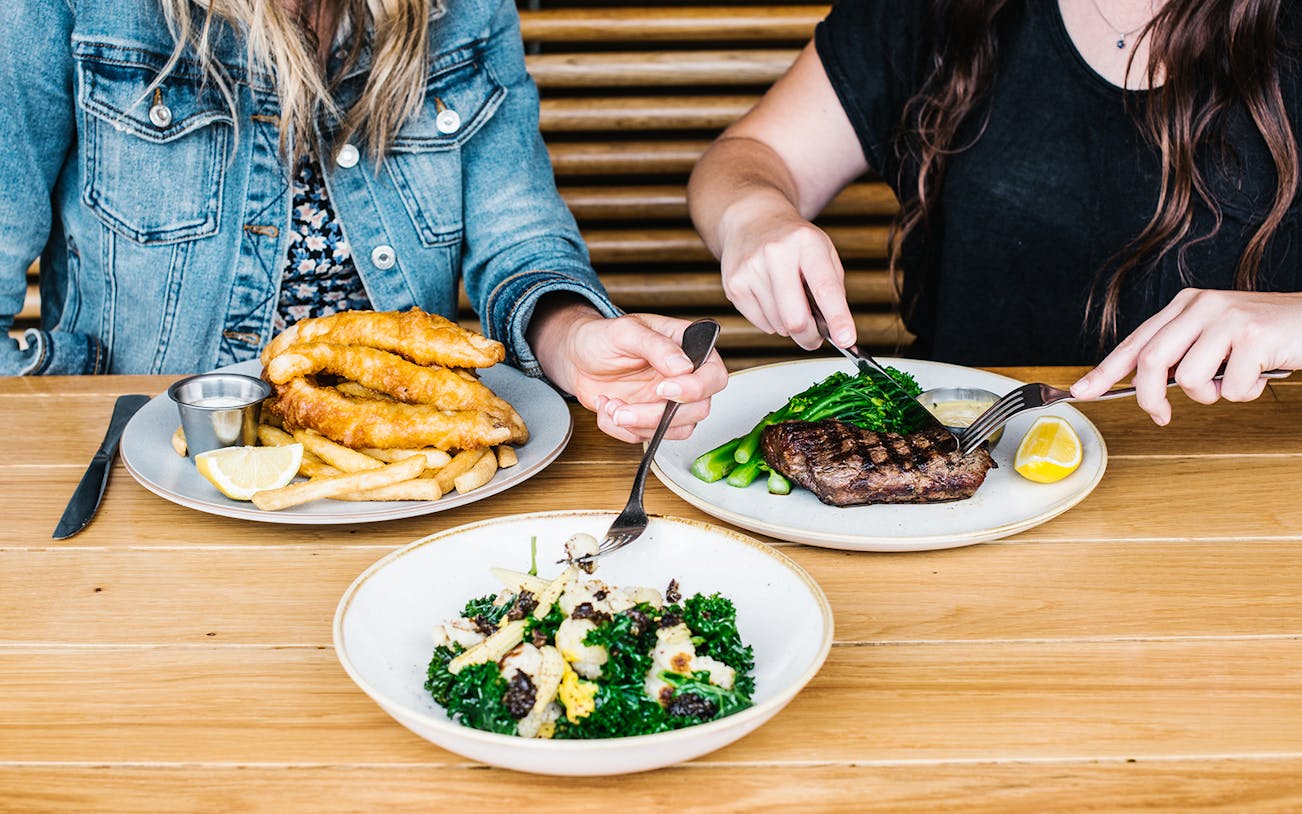 Dining at Opera Bar with fish and chips, steak, and salad, Sydney Opera House Tour.