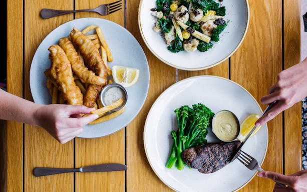 Dining at Opera Bar with fish and chips, steak, and salad, Sydney Opera House Tour.