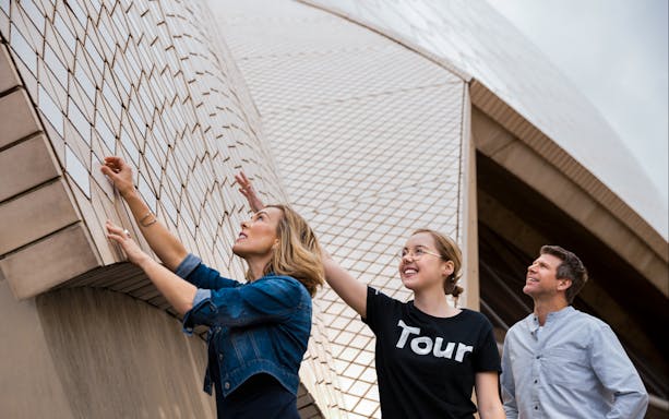 Tourists exploring the tiles of the Sydney Opera House during a guided tour.