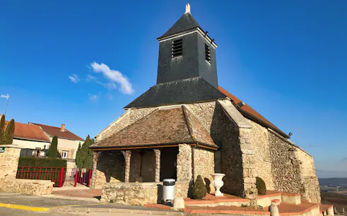 Stone church in Reims, France, with blue sky backdrop on Champagne tour from Paris.
