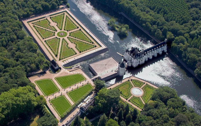 Aerial view of Château de Chenonceau with its gardens and river in the Loire Valley, France.