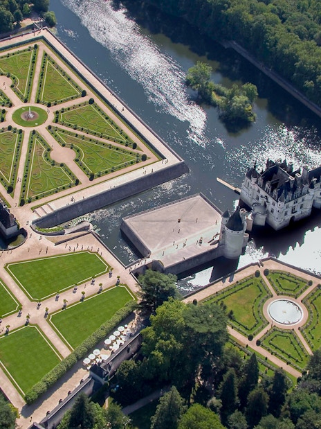 Aerial view of Château de Chenonceau with its gardens and river in the Loire Valley, France.