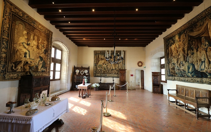 Loire Valley chateau interior with ornate tapestries and antique furniture.