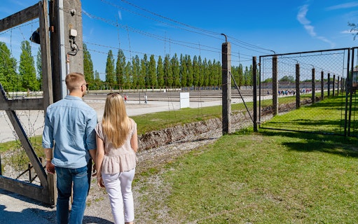 Visitors entering Dachau Concentration Camp site on a tour from Munich.