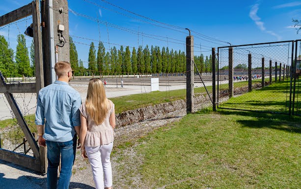 Visitors entering Dachau Concentration Camp site on a tour from Munich.