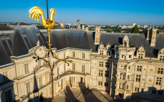 Golden rooster weather vane overlooking Blois Castle in France.