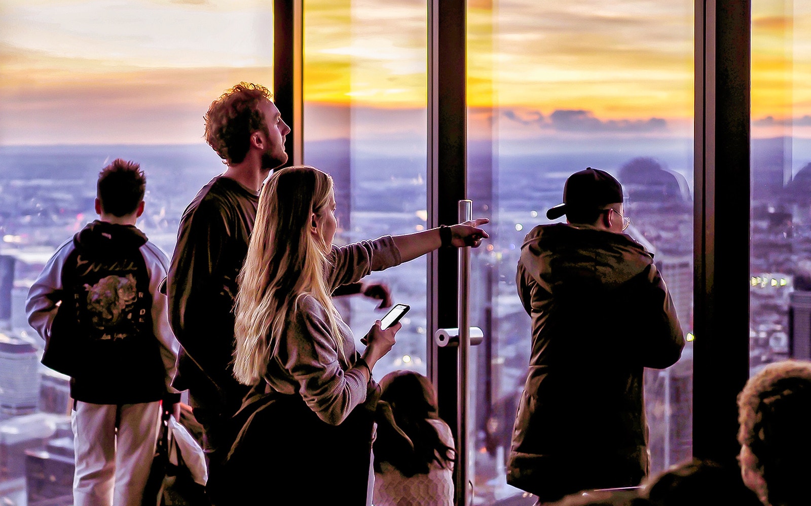 Visitors enjoying sunset views from Melbourne Skydeck at Eureka Tower.