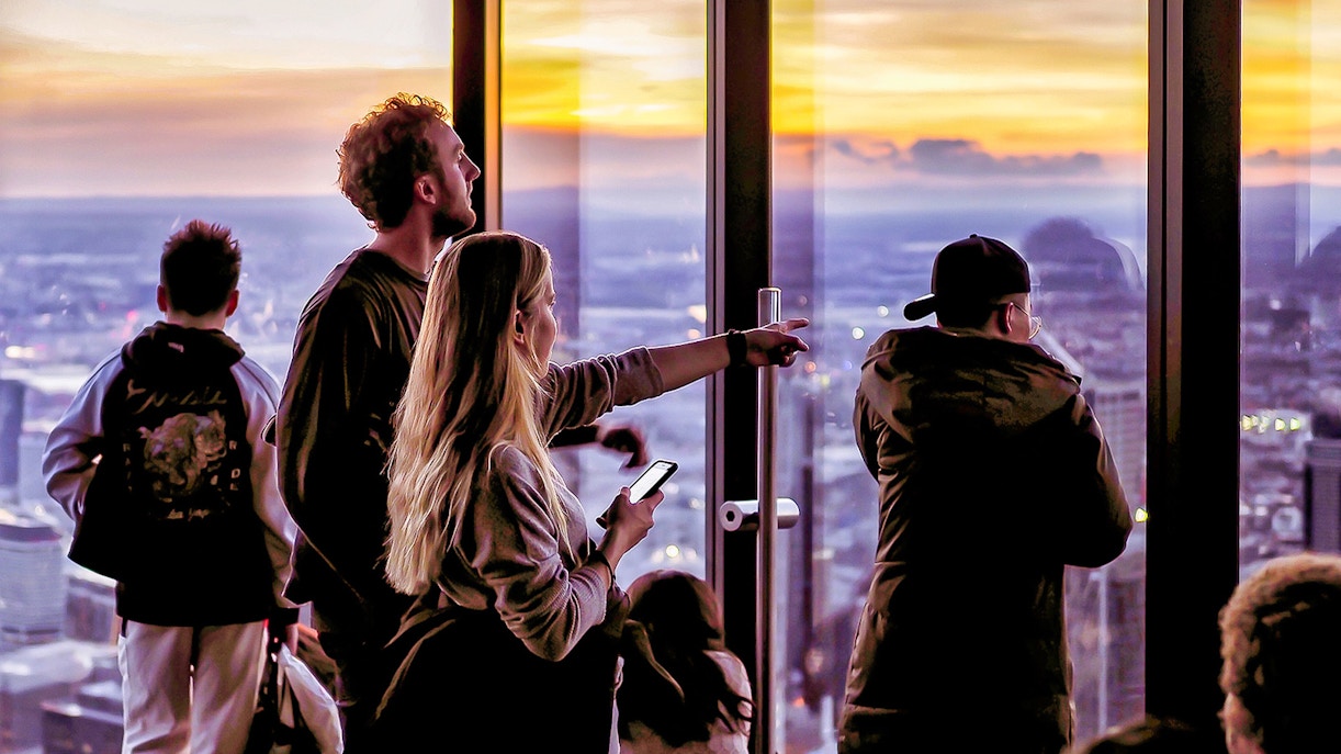 Visitors enjoying sunset views from Melbourne Skydeck at Eureka Tower.