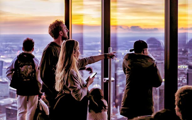 Visitors enjoying sunset views from Melbourne Skydeck at Eureka Tower.