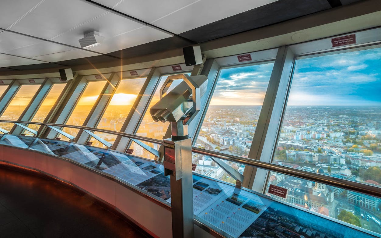 Observation deck view from TV Tower with cityscape and sunset.