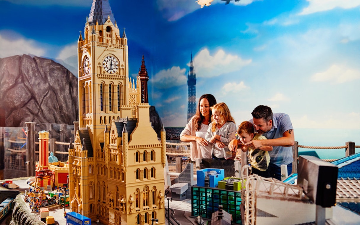 Family exploring LEGO cityscape at LEGOLAND® Discovery Centre Berlin.