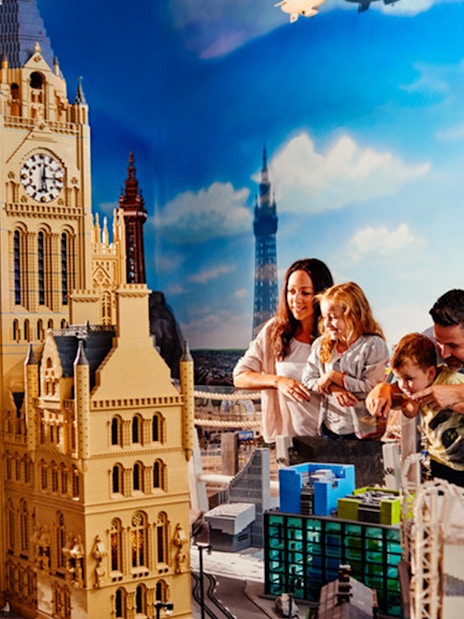 Family exploring LEGO cityscape at LEGOLAND® Discovery Centre Berlin.