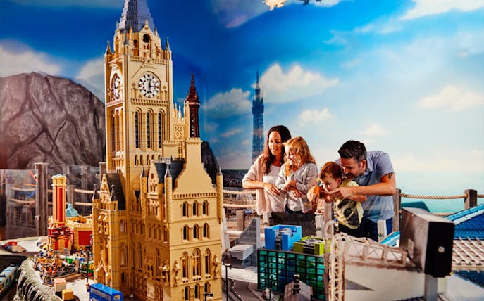Family exploring LEGO cityscape at LEGOLAND® Discovery Centre Berlin.