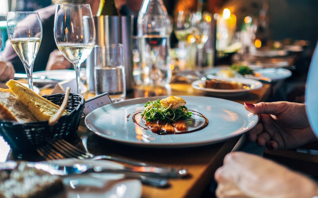 Lunch setting at Berlin TV Tower with gourmet dish and wine glasses.