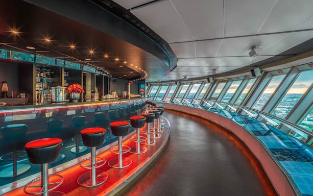 Dinner setting inside Berlin TV Tower with panoramic city views.