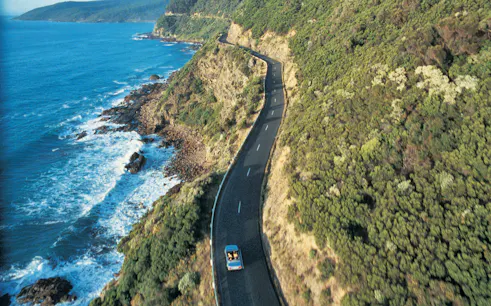 Coastal road along cliffs and ocean on Great Ocean Road Day Tour.