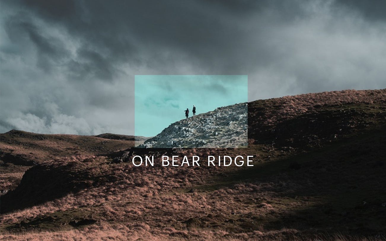 Hikers on a rocky hill under cloudy skies at Bear Ridge.