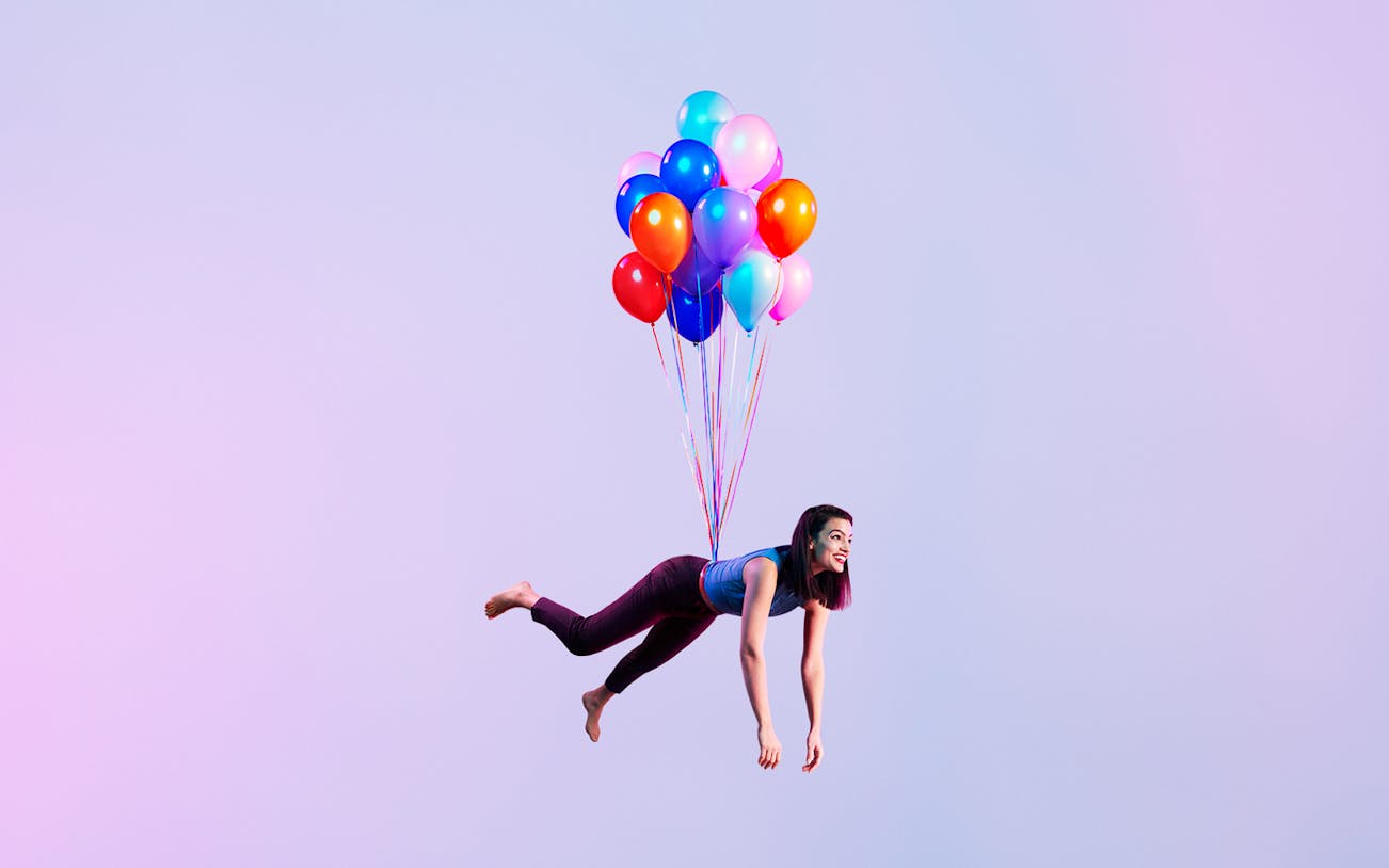 Person floating with colorful balloons against a purple sky, related to Orpheus in the Underworld.
