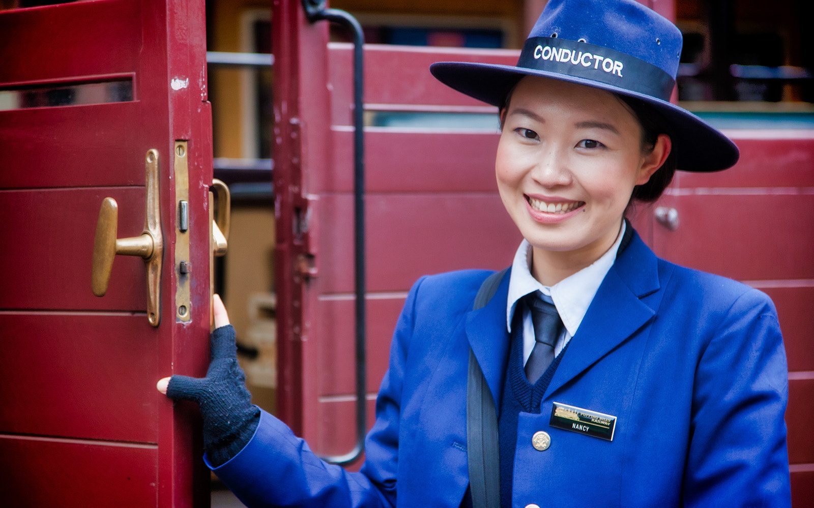 Conductor in blue uniform on Puffing Billy Steam Train, Australia.