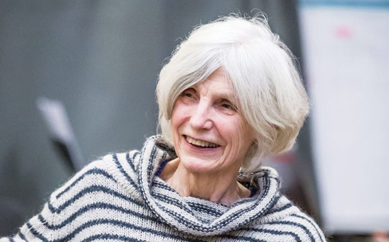 Elderly woman smiling during a rehearsal for Glass's "Bluebeard" opera.