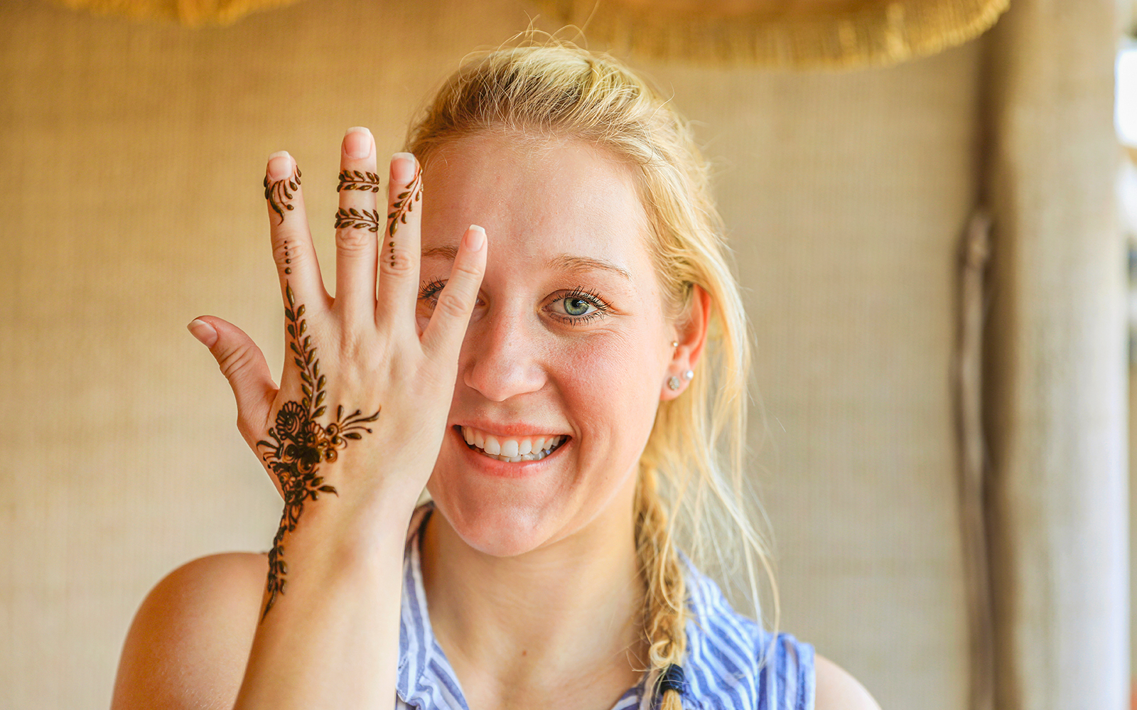 Henna design on woman's hand during Red Dunes Quad Bike tour.