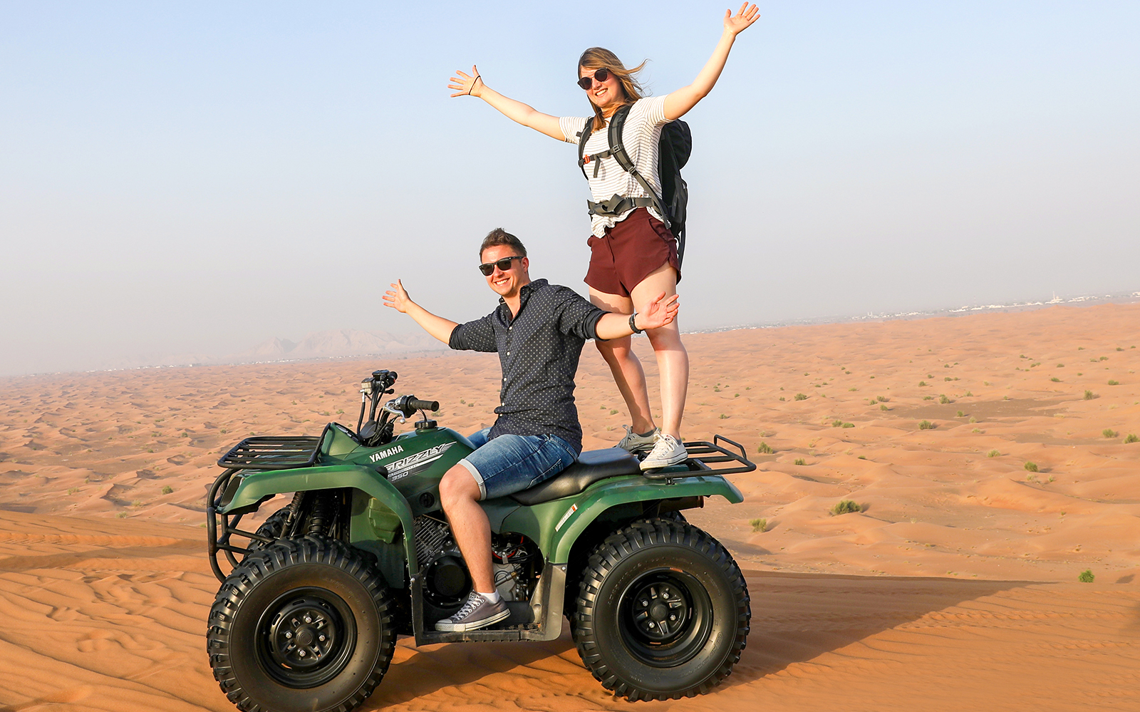 Two people enjoying a quad bike ride in the desert during a 50 min quad biking tour.