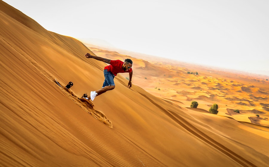 Premium Morning Quad Bike, Sandboarding and Camel Ride
