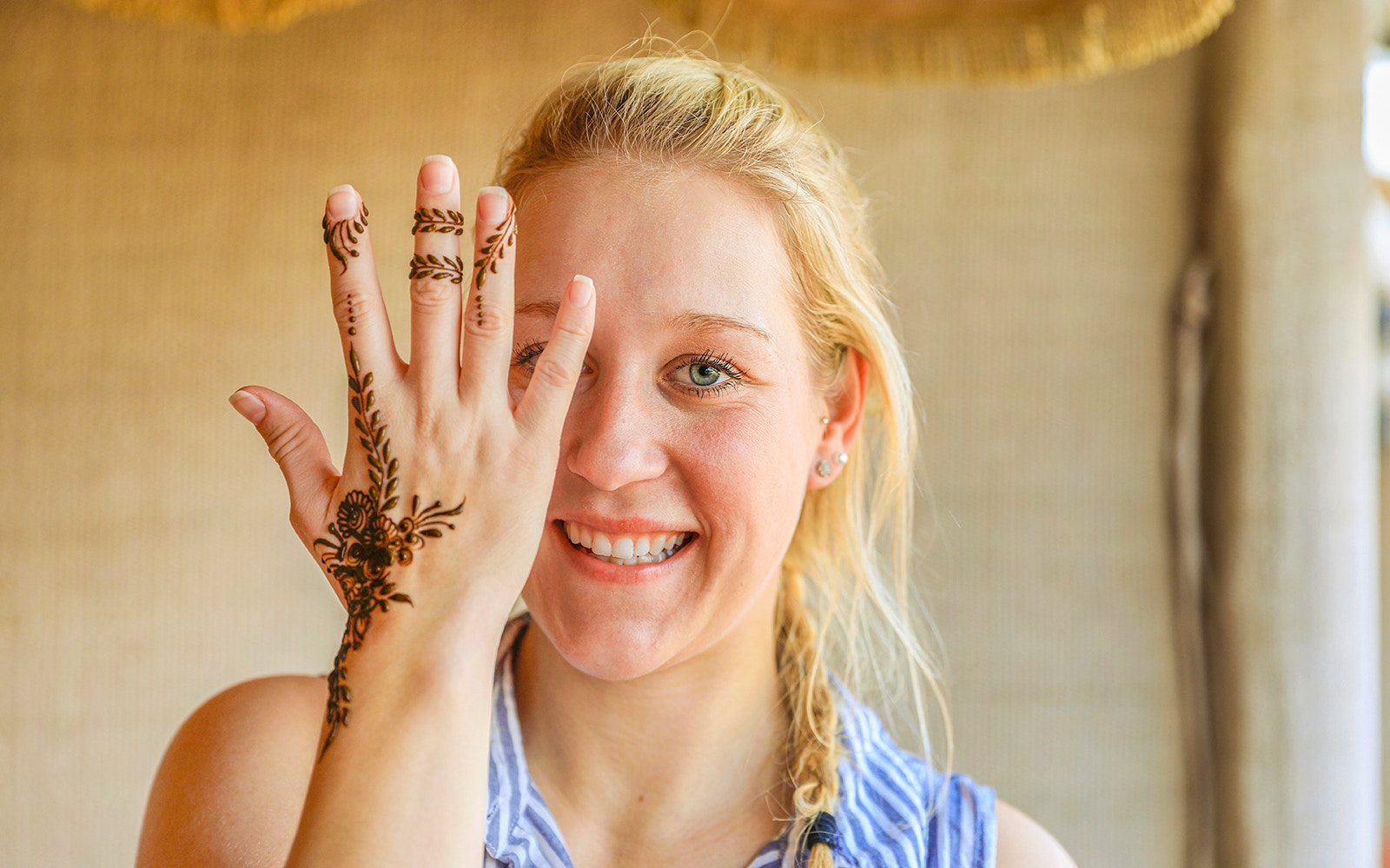 Henna design on hand during Bedouin Desert Safari experience.