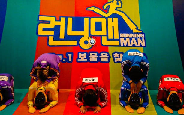 Participants bowing at Running Man Thematic Experience Center in Seoul.