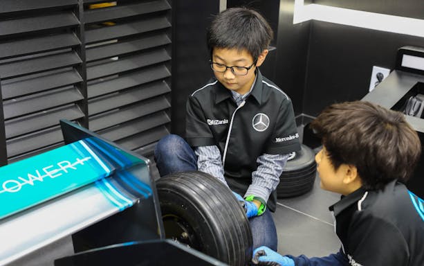 Children assembling a car tire at Kidzania Seoul.