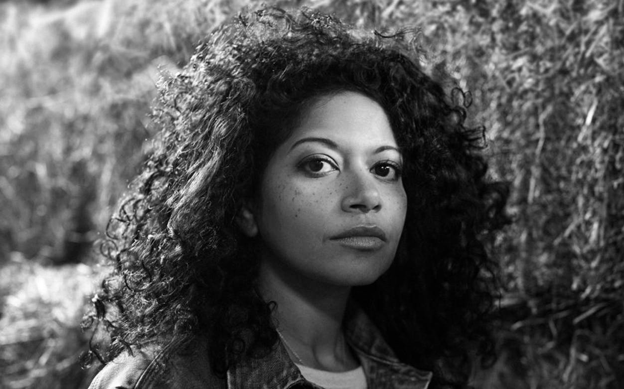 A person standing in front of hay bales, related to the musical Oklahoma!