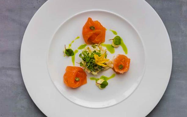 Smoked salmon with greens on a white plate, Bateaux London Lunch Cruise.