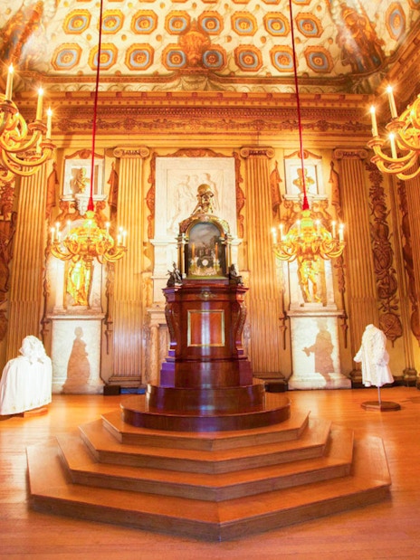 Kensington Palace ornate room with chandeliers and statues, London.