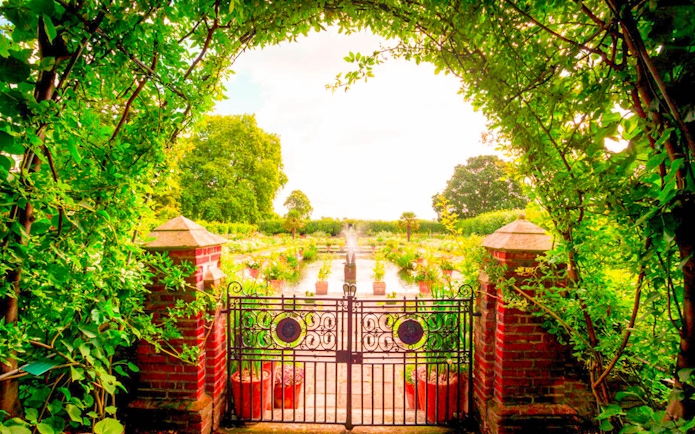 Garden view through ornate gate at Kensington Palace, part of 3 Palace Pass tour.