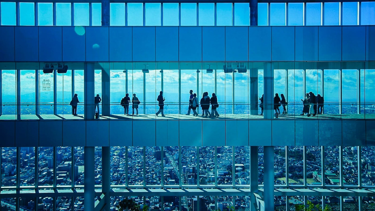 Visitors at HARUKAS 300 Observatory with Osaka skyline view.