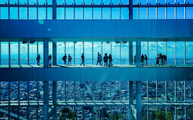 Visitors at HARUKAS 300 Observatory with Osaka skyline view.