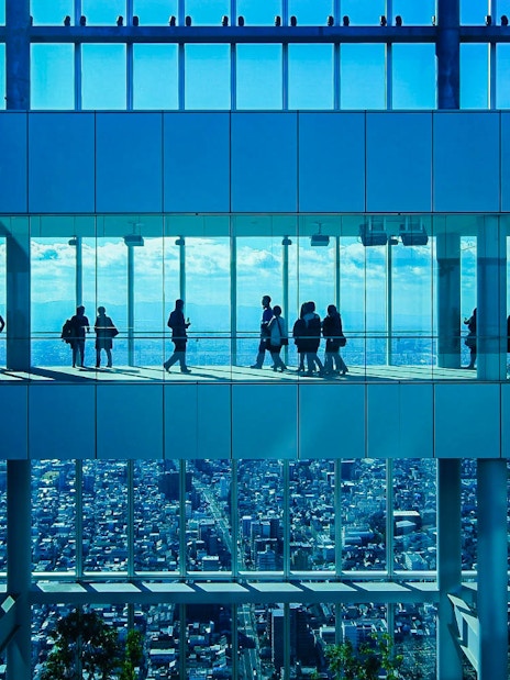 Visitors at HARUKAS 300 Observatory with Osaka skyline view.