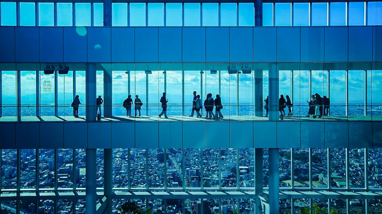Visitors at HARUKAS 300 Observatory with Osaka skyline view.
