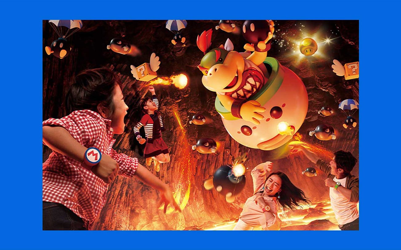 Children and adults in a cave-themed attraction with animated characters and fire effects, Test Sri Hari.